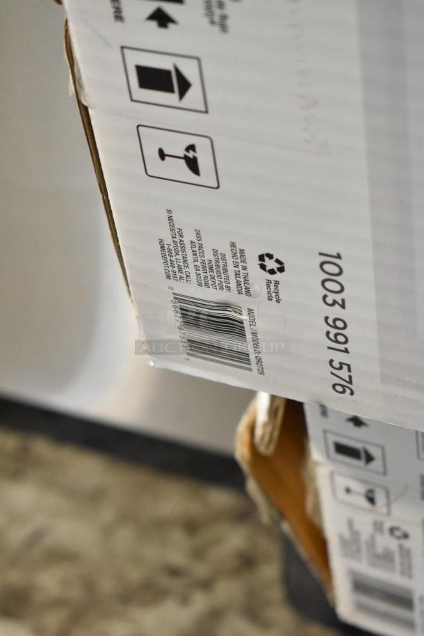 Cardboard box with handle with care symbols, barcode, and model number 1003 991 576. Made in Thailand. 