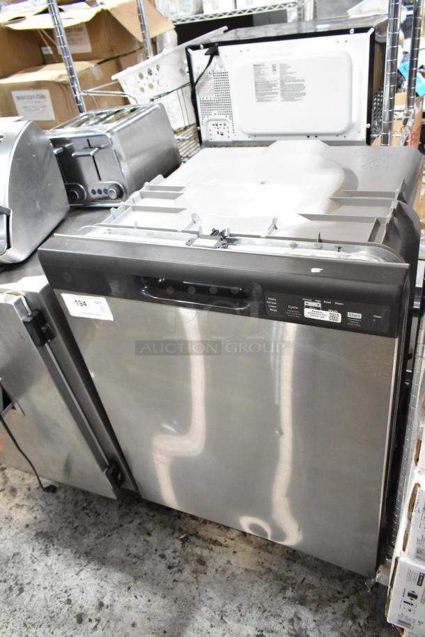 Stainless steel dishwasher with digital control panel, used. Auction lot tag: 194. Multiple cycle options visible.