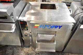 AutoFry commercial fryer, stainless steel, front loading design, digital controls, with visible wear, safety handle.
