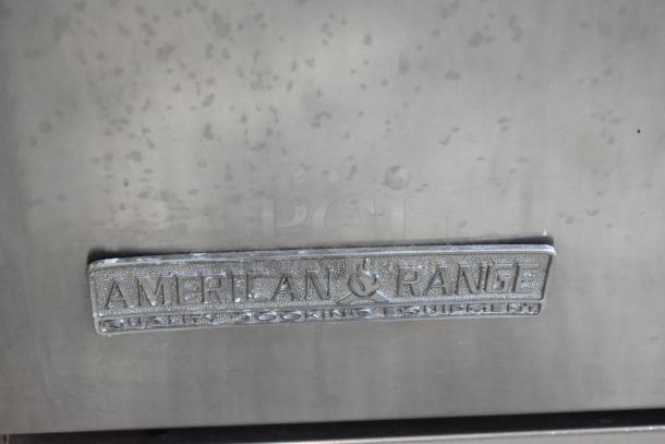 American Range stainless steel appliance panel with logo and "Quality Cooking Equipment" label. Visible wear.