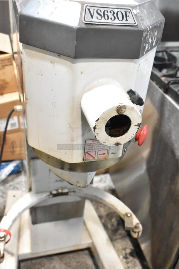 Industrial mixer, model VS63OF, with visible wear and rust. Warning label advises on use and safety.