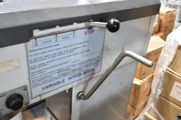Variable speed mixer with control levers, operating instructions, and speed settings label visible. Used condition.