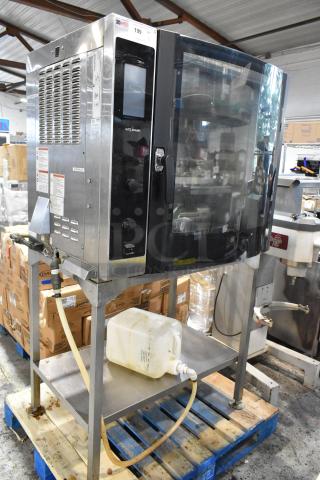 Alto-Shaam commercial oven with digital controls, stainless steel exterior, on metal stand, used condition with visible wear.