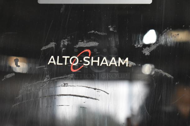 Alto-Shaam logo on a scratched black surface, indicating brand identification.