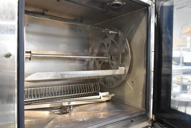 Commercial stainless steel rotisserie oven interior, rotating spit mechanism, good condition, capacity for multiple rows.