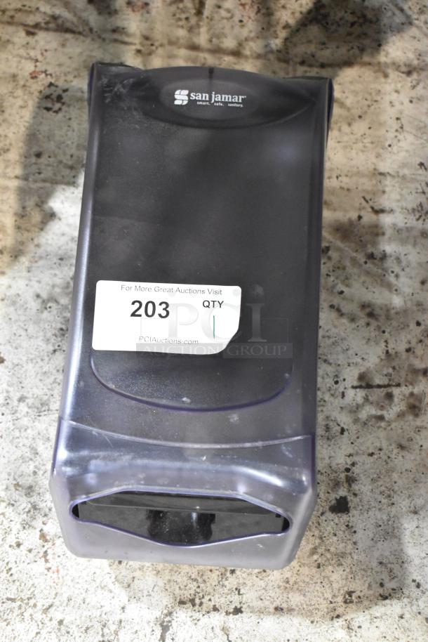 San Jamar towel dispenser, black, with model label and auction tag 203. Used condition.
