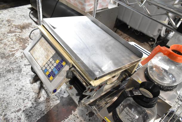 Commercial digital scale with keypad; stainless steel platform; moderate wear. Includes two coffee decanters.