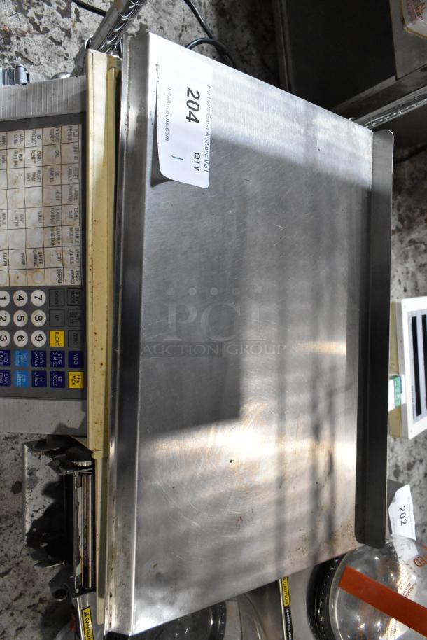 Metal digital weighing scale with numeric keypad, display panel, and auction label "204". Used condition.