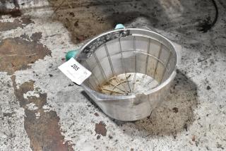 Metal strainer with green handles, visible wear and rust stains, auction tag numbered 205 attached, on a worn surface.