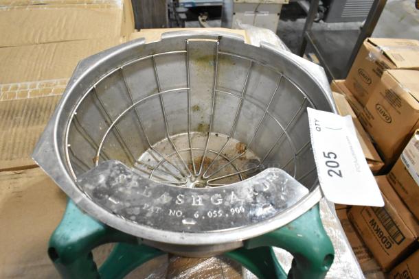 Stainless steel splash guard with wire mesh, marked "SPLASHGUARD" and patent number, showing signs of wear. Auction tag 205.