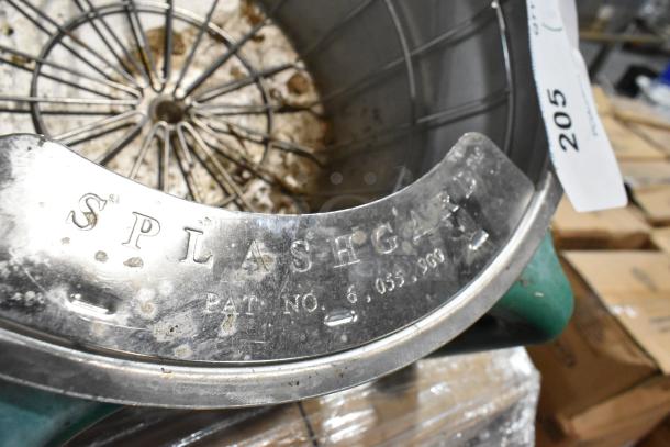 Splashguard with patina, labeled "SPLASHGAURD" with patent number 6,055,900, attached to a green base, condition worn.