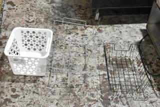 Set of three storage baskets: white perforated plastic with label "207 QTY VX3," and two metal wire frames. Used condition.