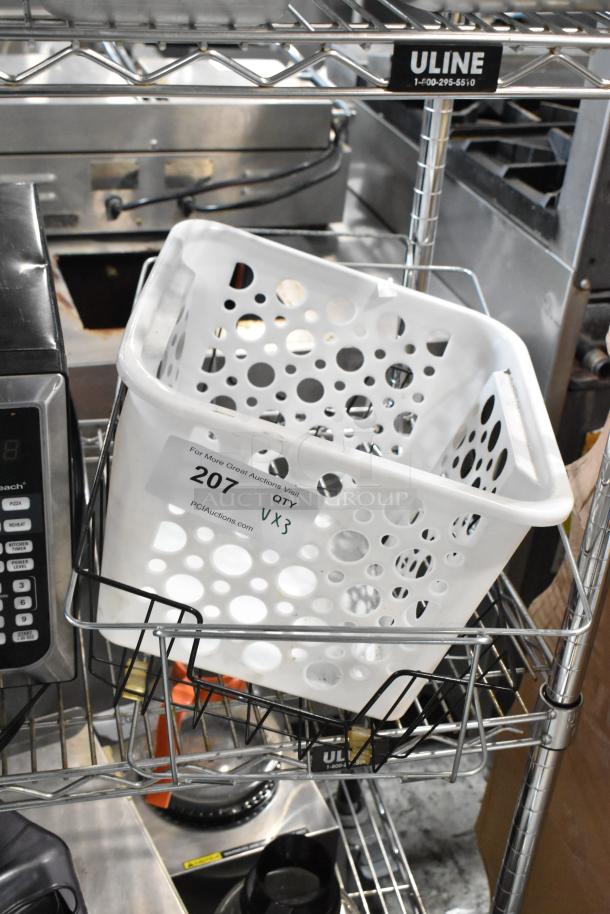 White perforated plastic basket on Uline metal shelving, tag marked '207 QTY x3,' in used condition.