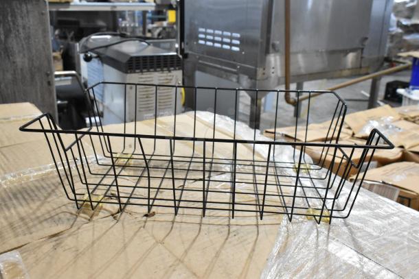 Black metal wire basket, rectangular, sturdy condition, placed on a cardboard surface.