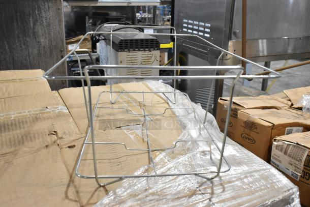 Metal wire rack in good condition, placed on cardboard-covered pallet. Ideal for storage or organization.