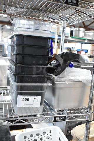 Stack of black and clear polycarbonate food storage bins with clamp; auction tag 209 indicating quantity and lot number.