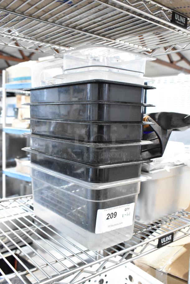 Stack of black and clear storage bins on metal shelf, labeled with auction number 209, in good condition.