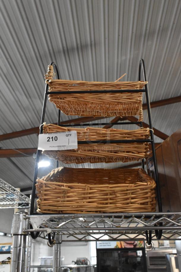 Three-tier wicker basket organizer with black metal frame, in good condition. Tag reads "210 Qty 1, PCIAuctions.com."