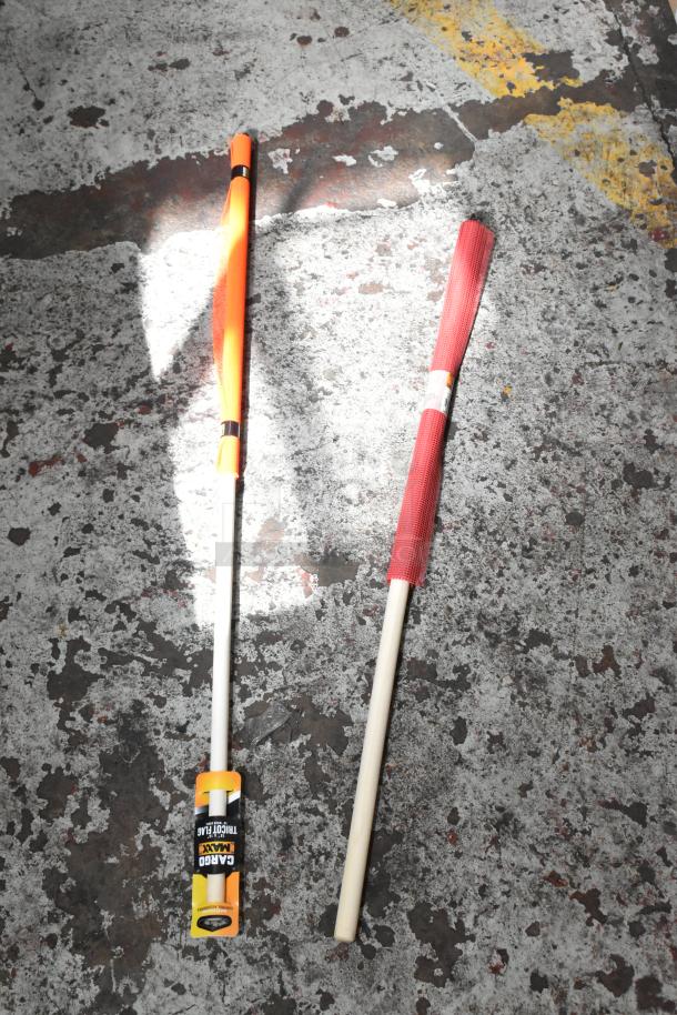 Two flag markers on ground; one orange, one red with "Cargo Maxx Traffic Flag" label. New condition.
