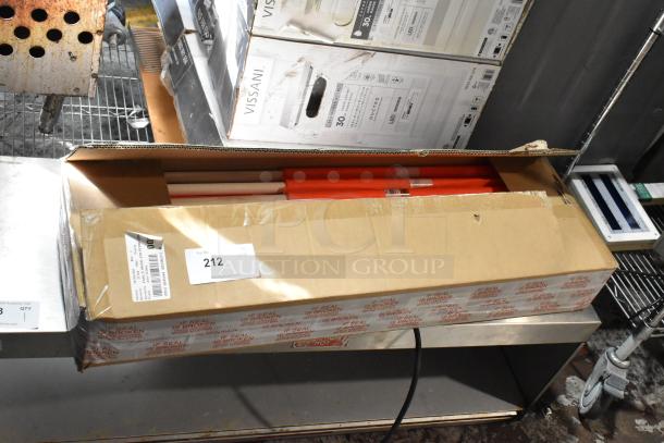 Open cardboard box with red rods inside, labeled "212" for auction, condition appears new. Box tape warns "IF SEAL IS BROKEN."