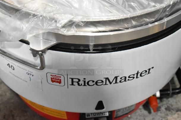 RiceMaster commercial rice cooker with label, stainless steel lid, used condition, capacity and model unspecified.