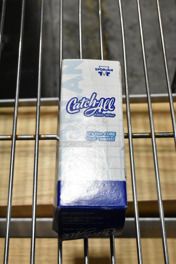 Sporlan Catch-All Filter Drier in original packaging, new condition. Markings indicate reliability in refrigerant filtration.