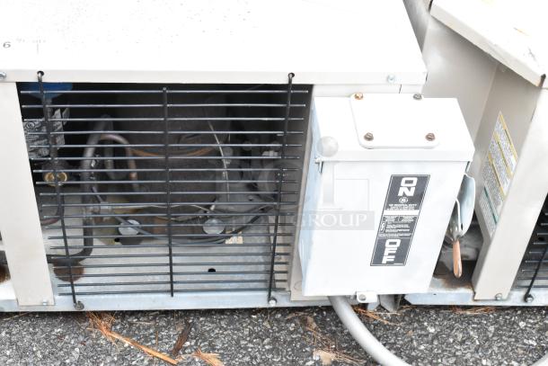 Industrial air conditioning unit with visible compressor and GE general duty switch. Features "ON/OFF" labeling, showing wear.