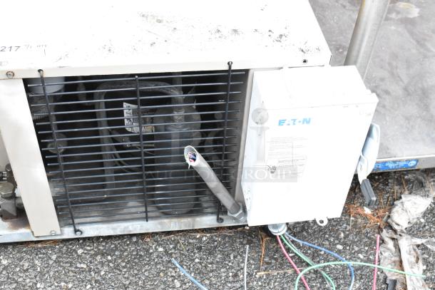 Industrial air compressor with Eaton control box, visible wiring, and protective grill. Moderate wear, suitable for repair or parts.