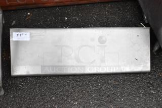 Metal panel with minor surface marks, auction tag "219" attached.