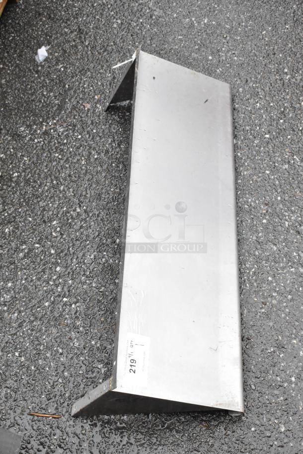 Metal angle bracket with a flat base, labeled "219/Lot," indicating auction lot number. Used condition.