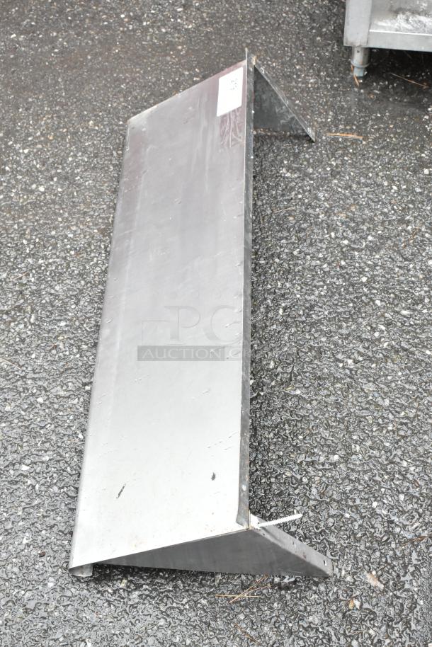 Stainless steel angle bracket, industrial-grade. Slight wear visible. Dimensions: approx. 3 feet. Auction label attached.