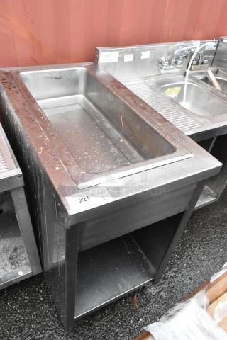 Stainless steel commercial sink with deep basin, rust and wear visible. Auction tag reads "221" and "QTY 1."