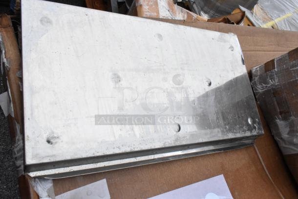 Aluminum sheet metal with rivets, used condition, visible scratches and wear, dimensions approximately 24x36 inches.