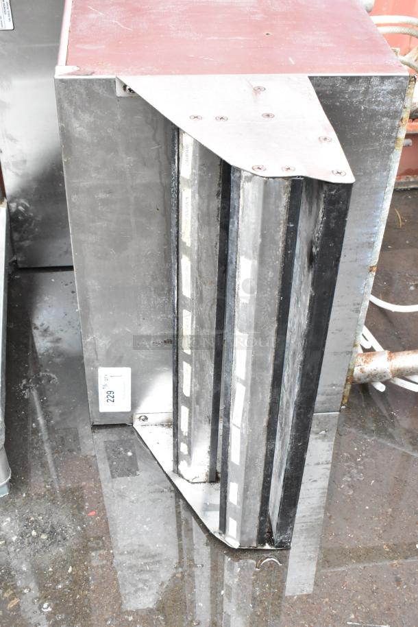 Stainless steel commercial ventilation hood, rectangular design, visible wear, numbered tag 229.