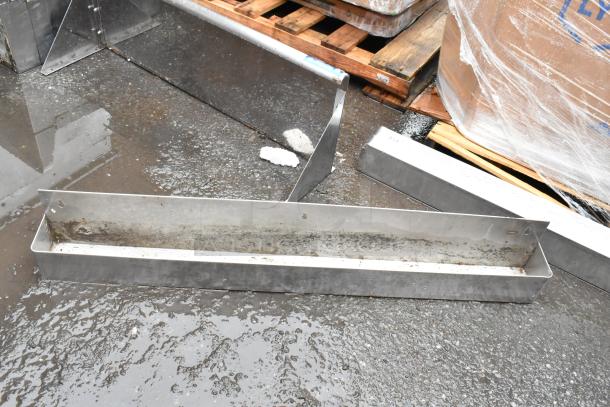 Metal gutter segment, stainless steel, used condition, showing surface wear and rust. Suitable for drainage systems.