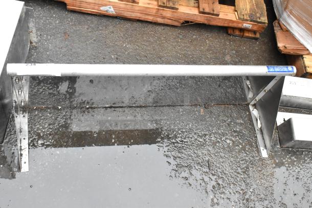 Metal guardrail with concrete mounting base, marked "234." Sturdy construction, suitable for safety or industrial use.