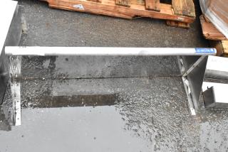 Metal guardrail with concrete mounting base, marked "234." Sturdy construction, suitable for safety or industrial use.
