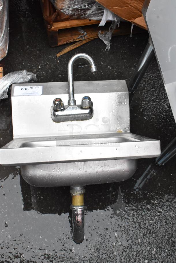 Stainless steel wall-mounted sink with dual handles and gooseneck faucet. Tag reads "235." Used condition.