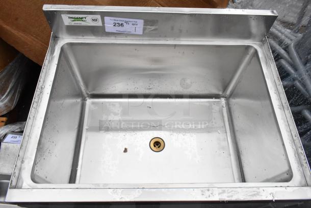 Stainless steel commercial sink by Regency, NSF certified, new condition, with visible labels indicating model and auction details.