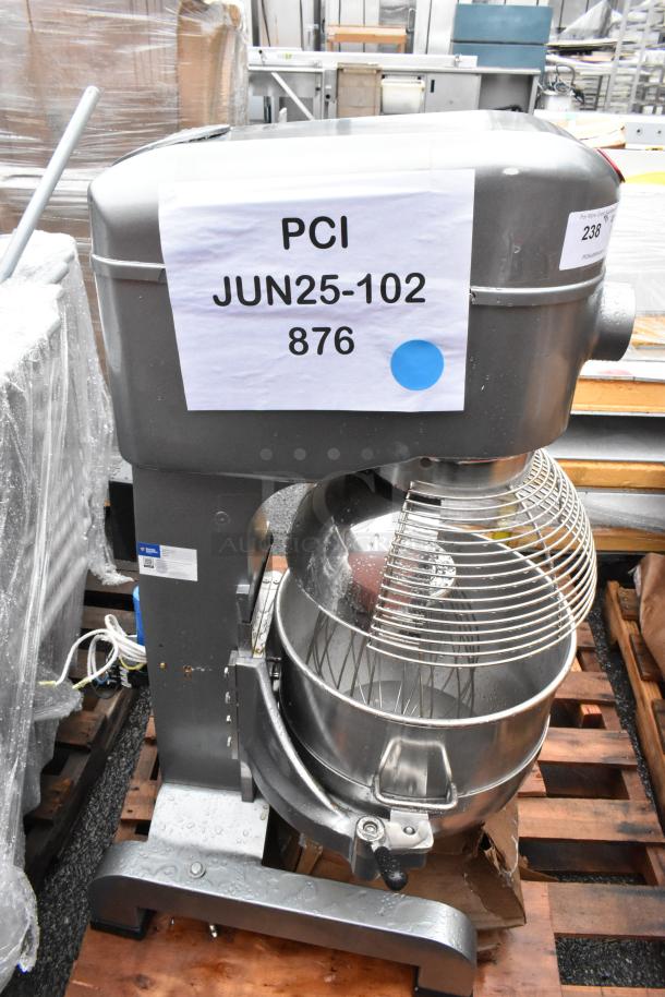 Commercial stand mixer, stainless steel bowl, labeled "PCI JUN25-102 876." Used condition, on pallet.
