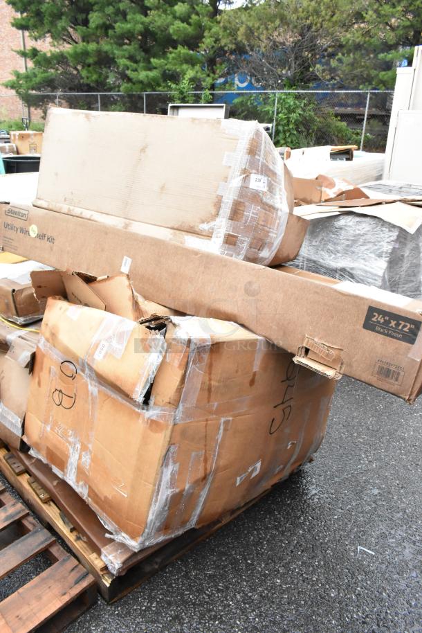 Damaged boxes of Steelton Utility Wire Shelf Kit, 24"x72", black finish, on a wooden pallet. Packaging is torn and taped.