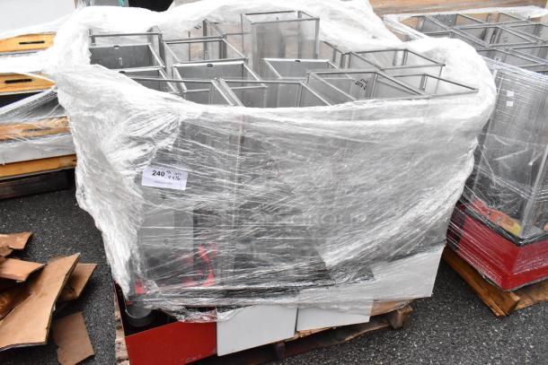 Wrapped stainless steel vending machine parts on a pallet. Protective plastic wrap with label "240 1 V XL". Ideal for resale.