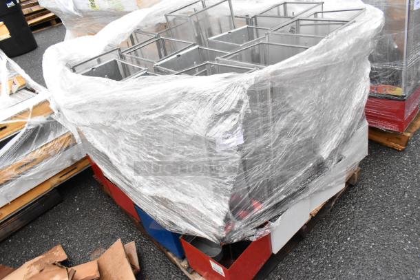 Stack of metal storage units wrapped in plastic on a pallet, new condition, suitable for inventory storage.