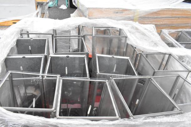 Metal frame bins, 12 units, wrapped in plastic on a pallet. Bins are in good condition, suitable for storage or organizational use.