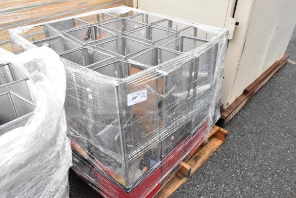 Steel grid shelves on a pallet, wrapped in plastic. Label reads "241 QTY 116." Used condition.