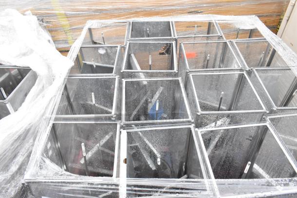 Stack of metal and glass display case frames, partially wrapped in plastic. Good condition, sturdy build.