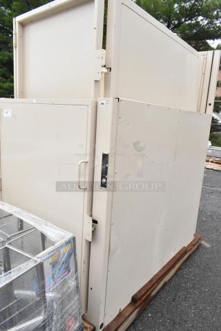 Large, beige industrial cabinet with metal handles and visible wear marks. Labels indicate inventory information.
