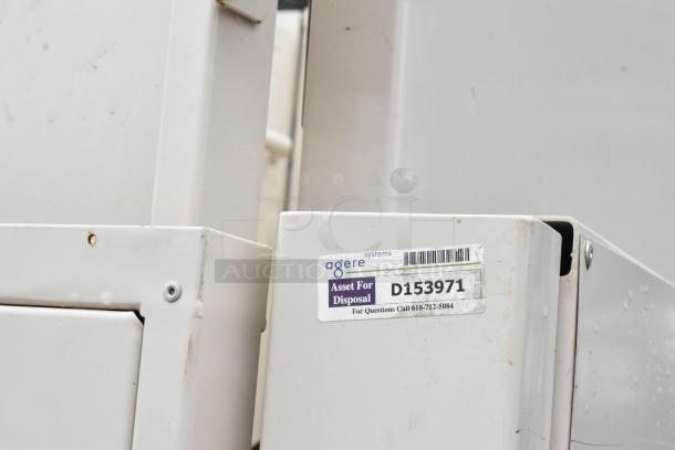 White metal enclosure with "Agere Systems" label, marked "Asset For Disposal" and code "D153971," in used condition.