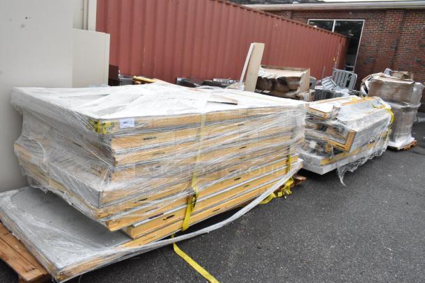 Stacked pallets with concrete slabs wrapped in plastic. Yellow straps secure the load. Label reads "243". Outdoor setting.