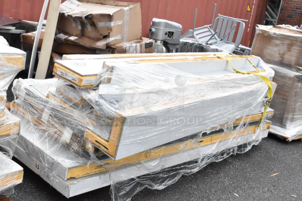Stack of white industrial shelving units wrapped in plastic on pallets, with visible labels indicating dimensions and model. Suitable for warehouse use, in new condition.